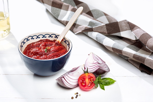bowl of chopped tomatoes on rustic table - Морковная икра (школьное питание)