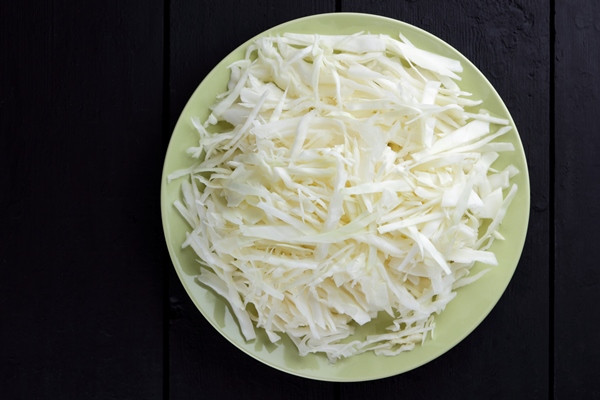 chopped cabbage on dark - Овощная икра (школьное питание)