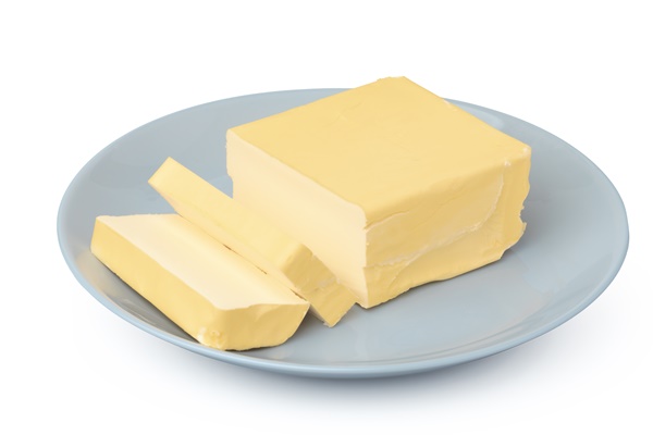 butter on white plate isolated on white background - Суп молочный с гречневой крупой (школьное питание)