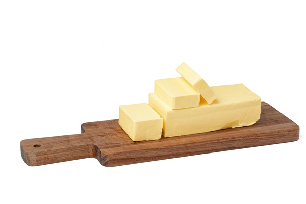 butter on wooden board isolated on white background 1 - Омлет натуральный (школьное питание)