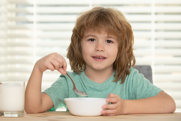 caucasian toddler child boy eating healthy soup in the kitchen - Каша гречневая с молоком, жидкая (школьное питание)