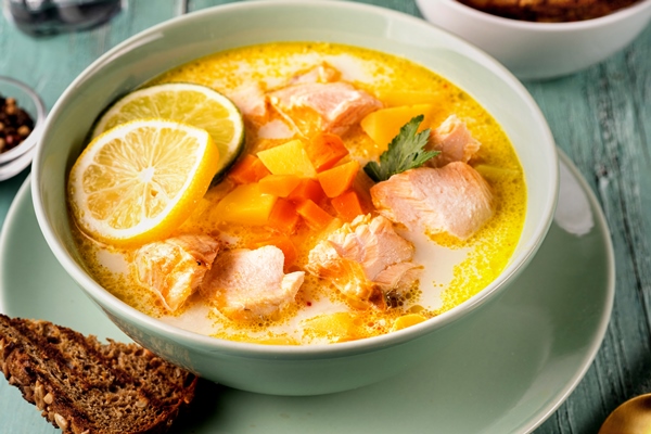 close up of a plate with delicious salmon fish soup - Суп рыбный сливочный с горбушей (школьное питание)