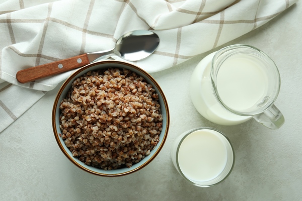 concept of tasty eating with buckwheat on white textured table - Суп молочный с гречневой крупой (школьное питание)