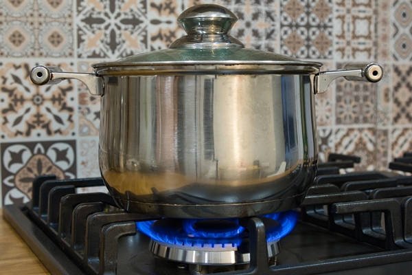 cooking on a gas stove the pot on gas burner home cooking concept - Суп картофельный с минтаем (школьное питание)