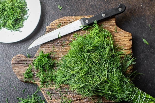 dill fresh green herb cut finely a knife on the table healthy snack copy space food background - Салат "Оливье" с крабами