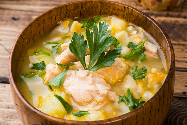 fish soup in a wooden bowl with fresh herbs 1 - Суп картофельный с минтаем (школьное питание)