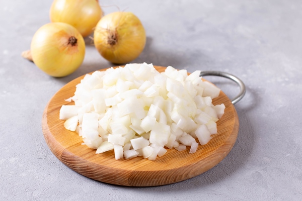 fresh chopped onions on wooden cutting board - Суп картофельный с макаронами (школьное питание)