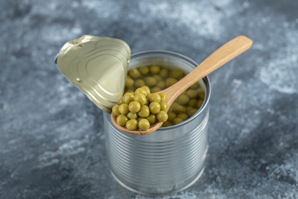 opened tin green peas and wooden spoon - Макароны отварные с овощами (школьное питание)