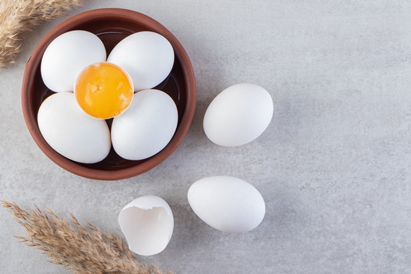 raw fresh white chicken eggs placed on a stone background 1 - Овощная запеканка с микрозеленью (школьное питание)