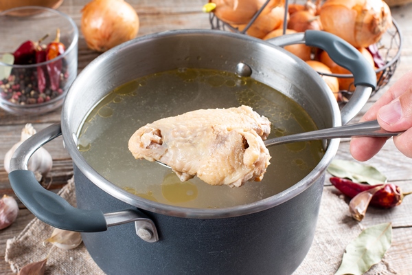 saucepan with chicken bouillon or bone broth on the wooden table paleo diet 1 - Суп картофельный с клёцками (школьное питание)