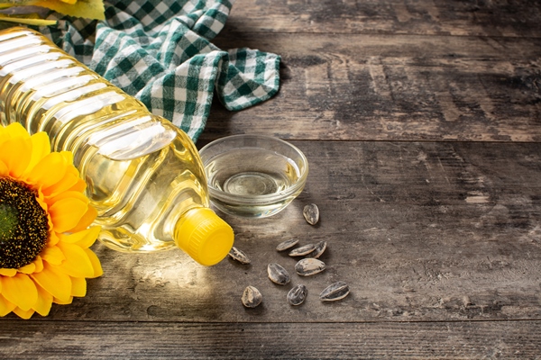 sunflower oil plastic bottle on wooden table 1 - Суп крестьянский с рисом (школьное питание)