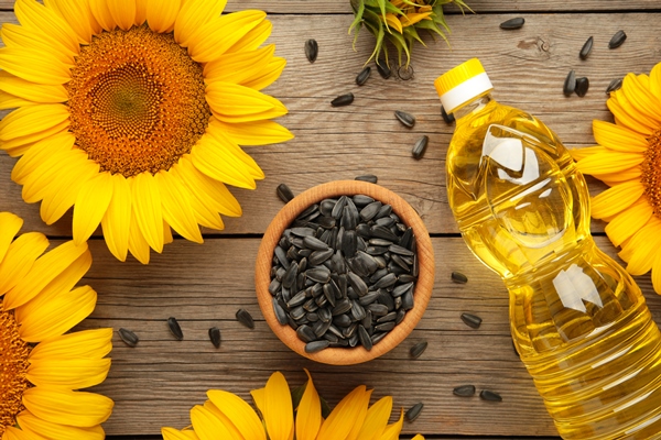 sunflower oil seed and sunflower on grey wooden background - Гороховый суп (школьное питание)