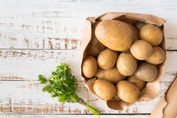 top view pile of potatoes in paper bag - Суп рыбный сливочный с горбушей (школьное питание)