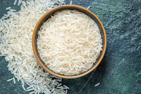 top view raw rice inside plate on dark desk - Каша "Дружба" (школьное питание)