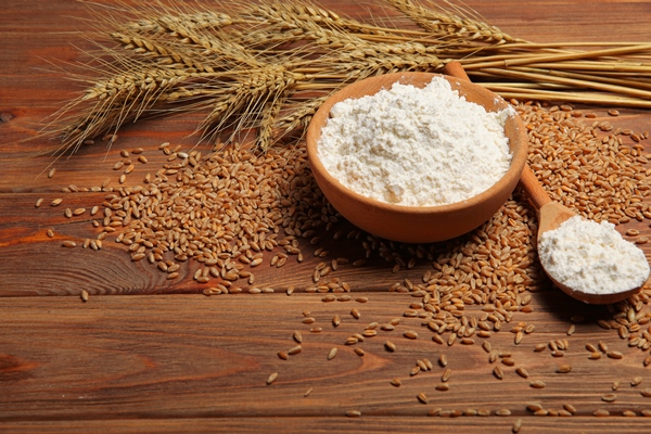 wheat flour and spikelets of wheat on a light background - Картофель отварной в молоке (школьное питание)