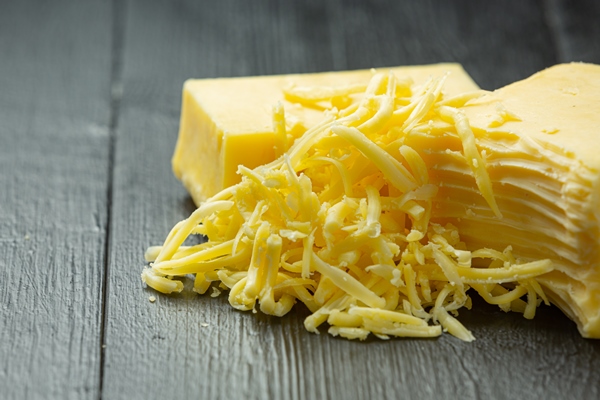 cheddar cheese on dark wooden surface 1 - Кулинарные традиции празднования Крещения Господня: вареники с картофелем, сыром и яйцом