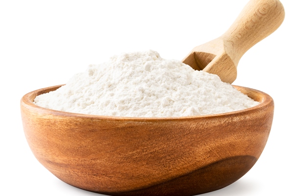 flour in a wooden plate with a scoop close up on a white background isolated - Соус сметанный (школьное питание)