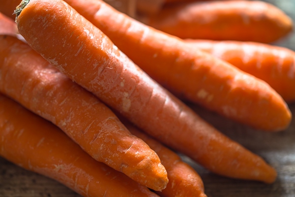 fresh organic carrots a bunch of carrots lying on wooden boards - Соус красный основной (школьное питание)
