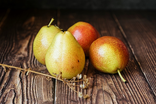 front view of delicious pears on wooden table - Груши в вине