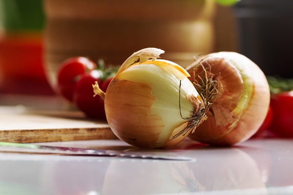 kitchen background cooking food concept onion on table vegetables on table cooking process - Рыба, запечённая в томате с овощами (школьное питание)