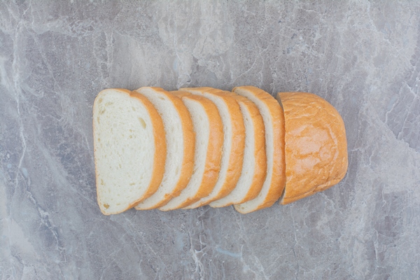 sliced of fresh bread on marble background 1 - Рыбная котлета из трески (школьное питание)