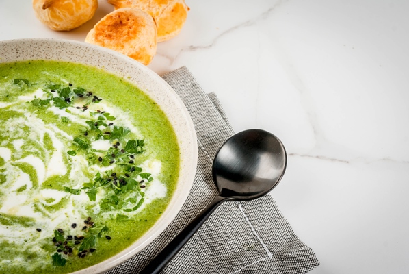 vegan diet food broccoli cream soup with cheese rolls greens on a white marble table copy space - Суп-пюре из редиса и лука-порея