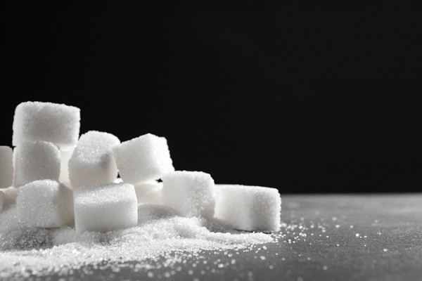 white sugar cubes over black close up - Компот из кураги (школьное питание)