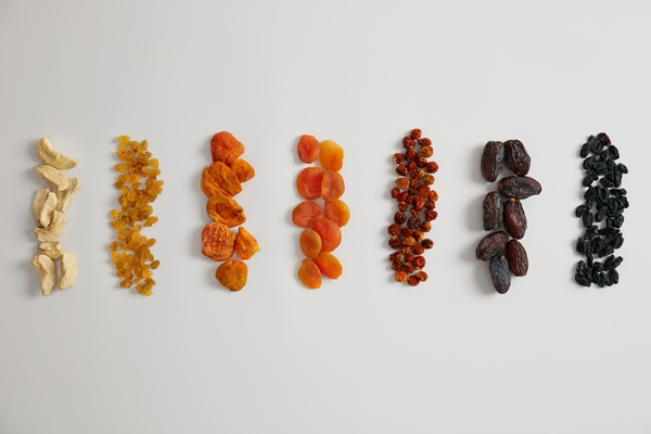 assortment of highly nutritious dried fruits rich in vitamins and minerals dried apple raisins apricot physalis barberry and dates on white background healthy snack can be added to porridge - Творожная запеканка в мультиварке