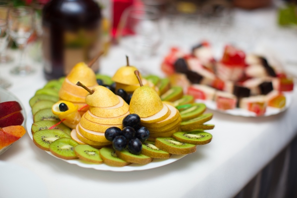 beautifully cut fresh fruit on the holiday table - Банкет