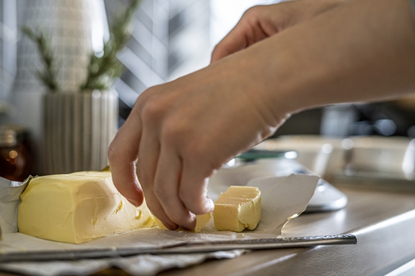 closeup of a person cutting the butter in a kitchen - Домашнее печенье с шалфеем