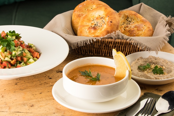 closeup shot of a soup and appetizers near basket of breads - Кулинарные традиции празднования именин
