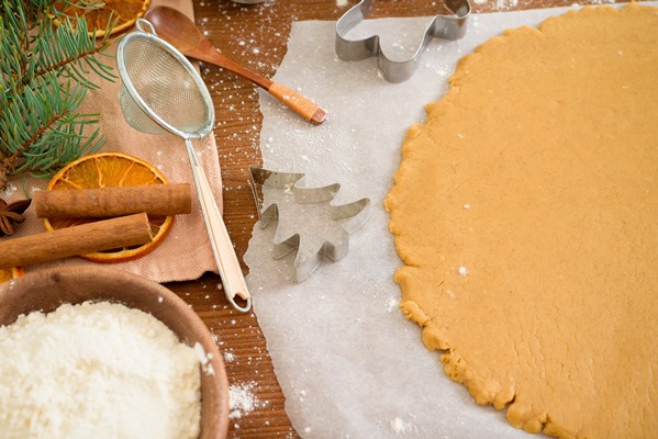 cut gingerbread out dough using gingerbread mold top view rolling pin cinnamon dried orange - Медовые пряники на молоке