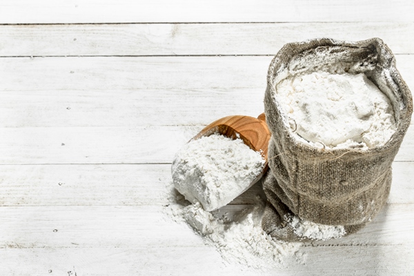 flour bag with shovel white wooden table - Вафли из дрожжевого теста