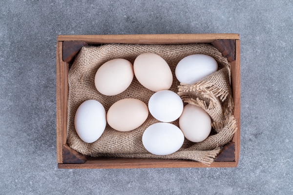 fresh white chicken eggs on a wooden basket - Манник в мультиварке