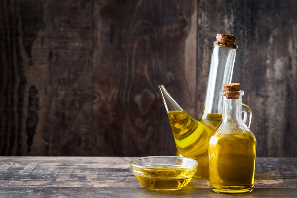 olive oil different glass bottles wooden table copy space - Вафли из дрожжевого теста