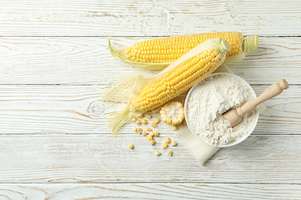 raw corn and flour on white wooden table - Рыба в кляре
