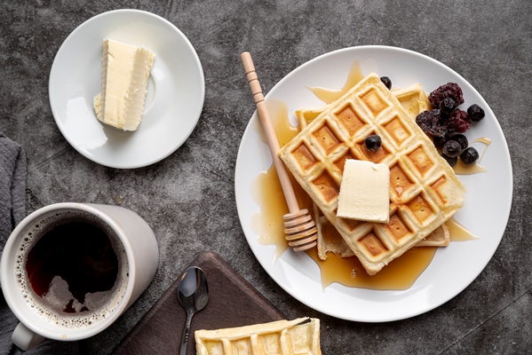 top view waffles plate with butter cup tea - Вафли из дрожжевого теста