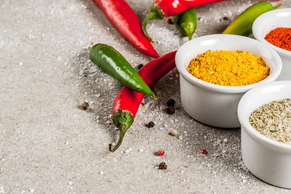 various spices and seasonings cooking turmeric curry paprika pepper chili dried basil salt fresh chili thyme grey stone - Запечённый нут
