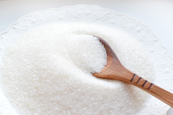 white sugar in a wooden spoon in bulk and cubes xa 2 - Оладьи яблочные дрожжевые, постный стол