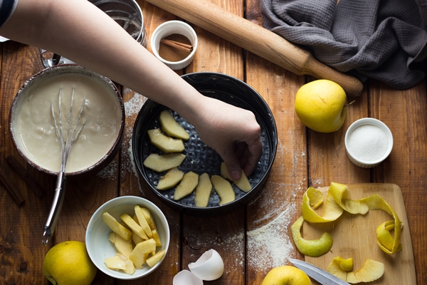 woman cooks apple pie wooden table process making pie 1 - Шарлотка со сливочным маслом