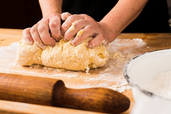 crop hands making dough - Булочки с маком