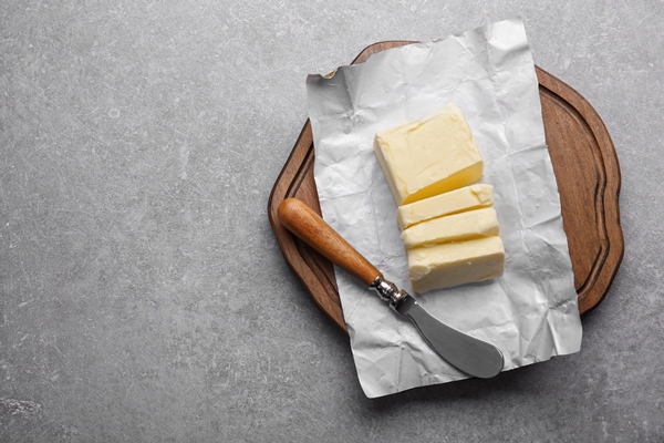 cutting board with piece unwrapped sliced butter knife grey background 1 - Начинка для блинчиков из капусты и яиц