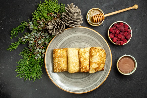 dinner background with delicious pancakes honey chocolate raspberry conifer cone black background - Блины, блинцы, блинчики!