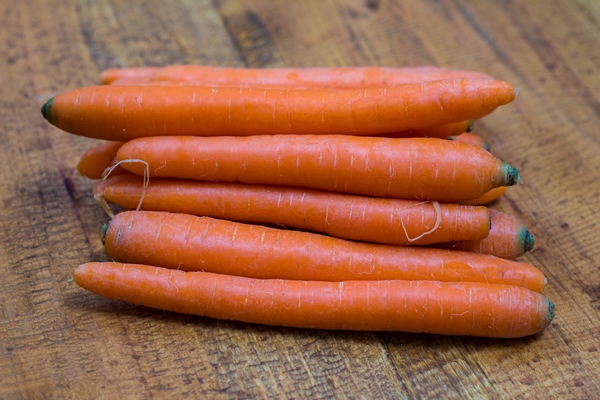 fresh organic carrots wooden background - Маринованная капуста по-петровски