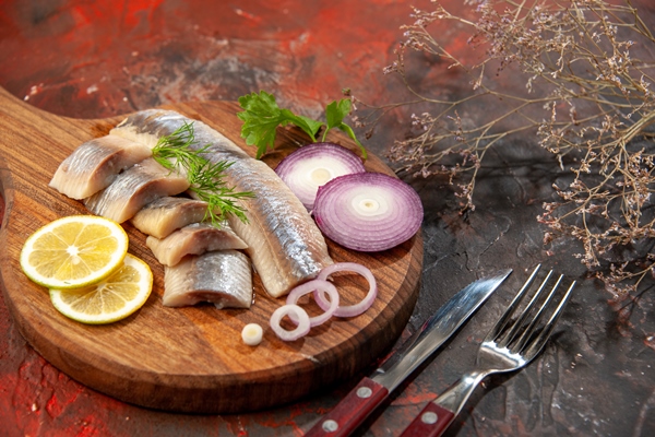 front view fresh sliced fish with onion rings lemon dark snack meal meat seafood color photo - Сельдь под лисьей шубкой
