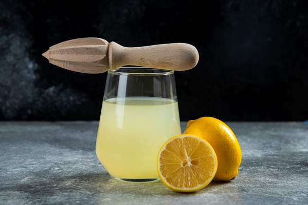 glass cup lemon juice wooden reamer - Лимонад с розмарином