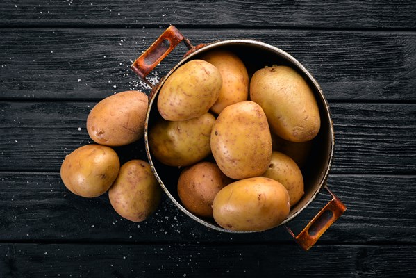 raw potatoes black wooden background cooking free space text top view - Картофельная запеканка "Особая"