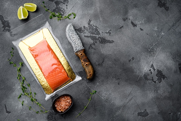 salmon fillets vacuum package set with herbs gray stone table background top view flat lay with copy space - Паста с форелью и овощами