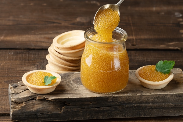 salted pike caviar in a glass jar on a wooden board top view - Форшмак для блинчиков