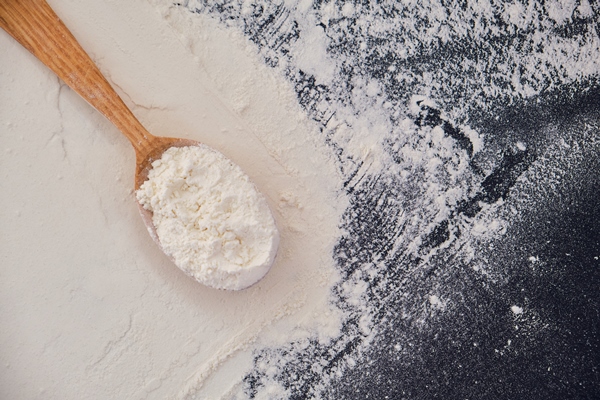 scattered flour black table flour wooden spoon - Фалафель из чечевицы